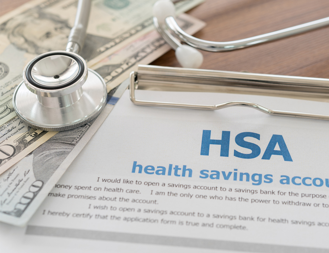 HSA form on clipboard with money and stethoscope