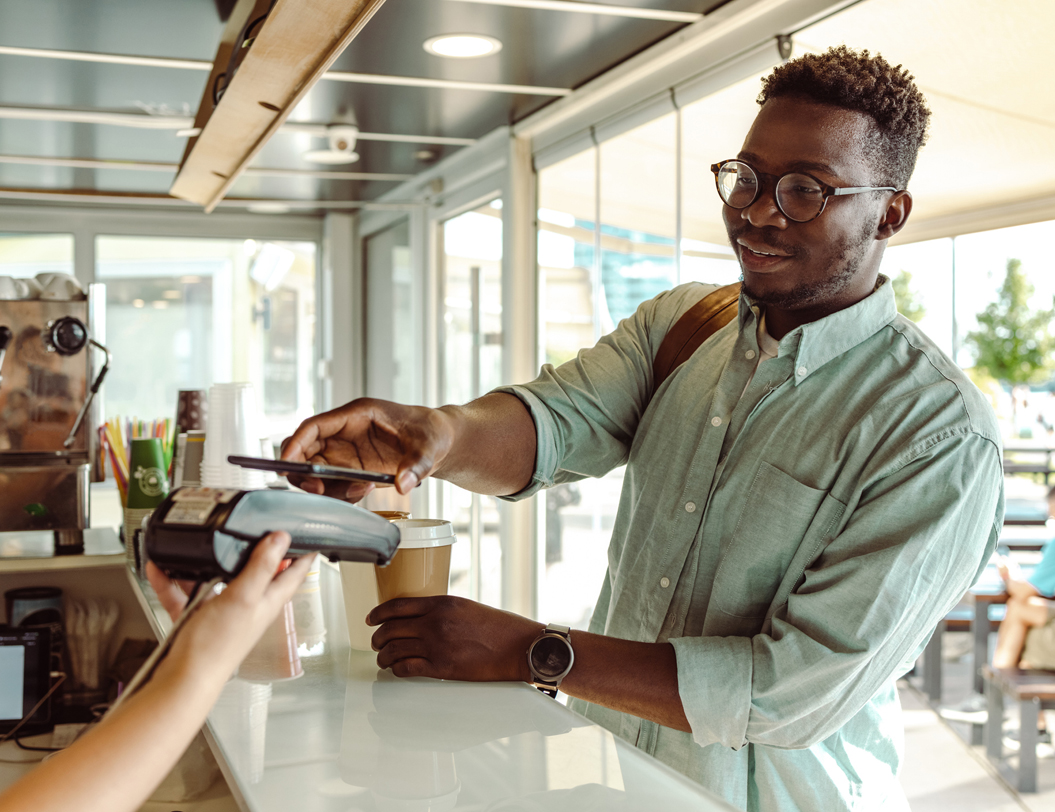 Man making a purchase at coffee shop