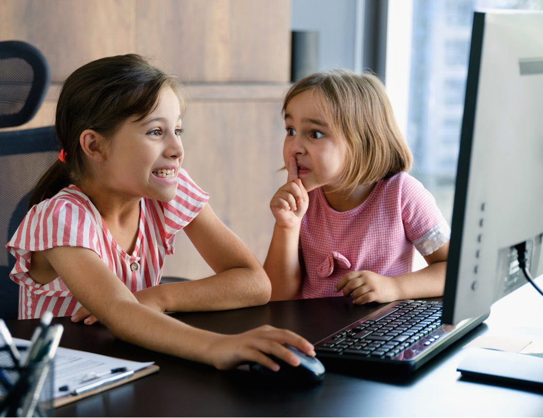 two girls using parents computer