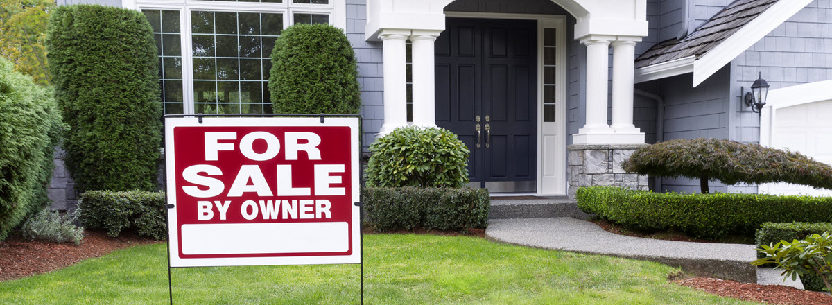 For Sale sign in front of a house