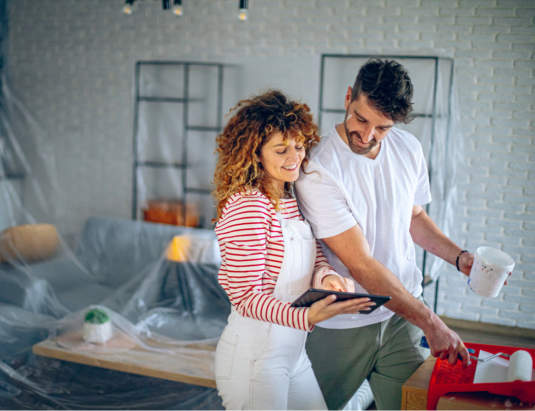 Young couple painting a room