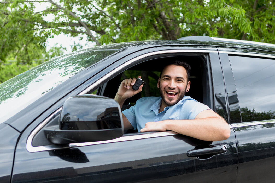 Man in a car holding key fob