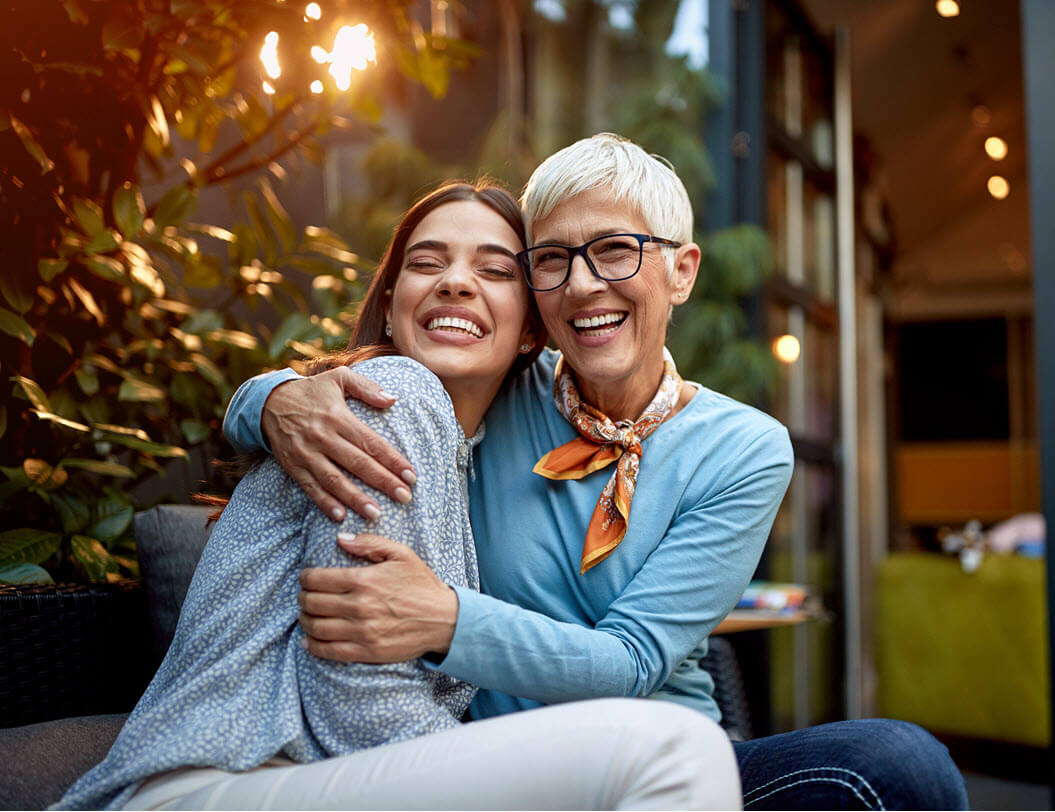 Mother and daughter hugging and smiling