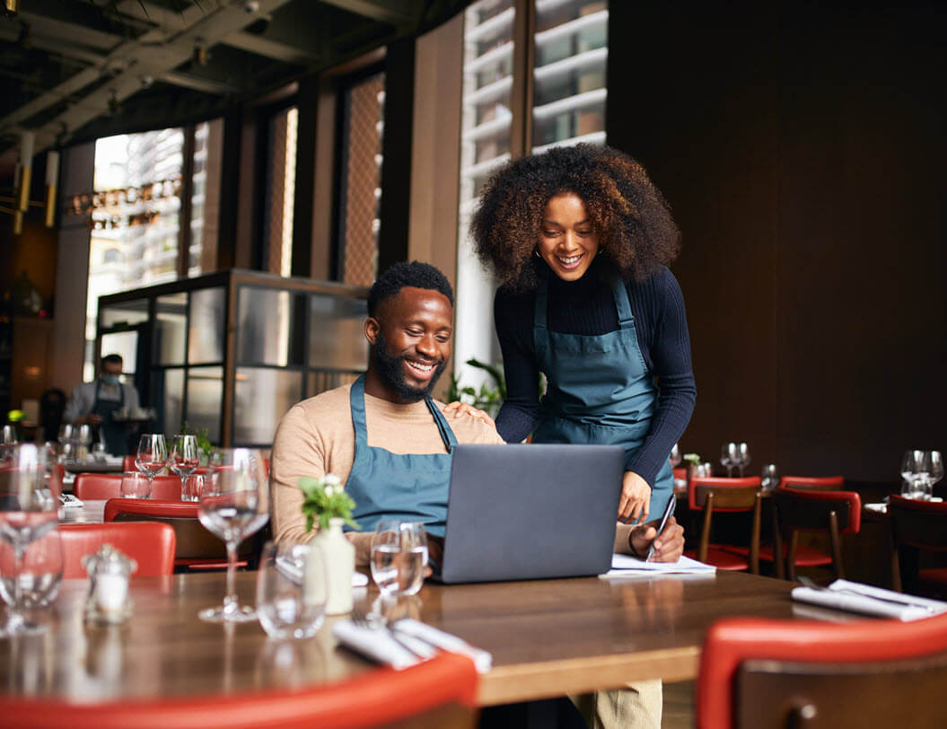 Restaurant owners sitting at a table going over their finances