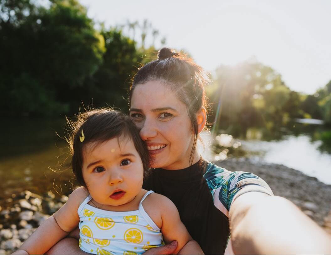 Woman and child taking photo outdoors