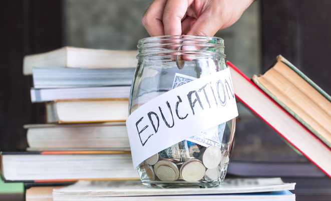 Money in a glass jar labeled education