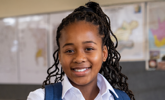 young girl standing in a classroom