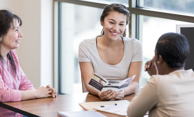 Young woman sitting with a financial advisor