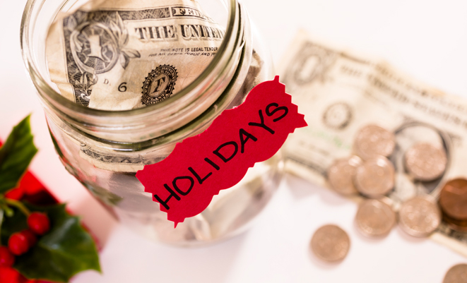 Money in a glass jar labeled holidays