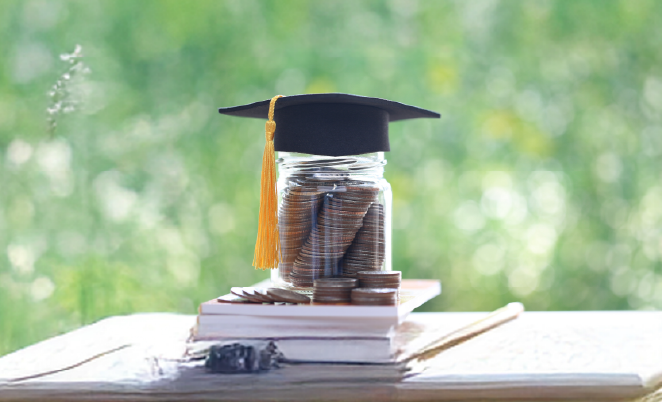Money in a glass jar with a graduation cap on top
