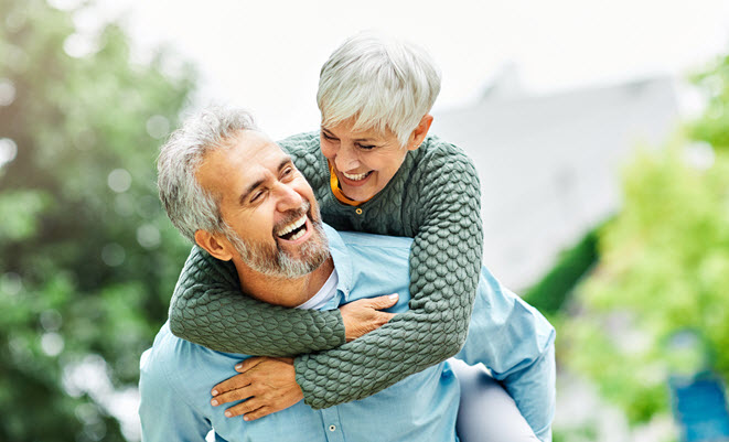 Mature couple, woman on man's back