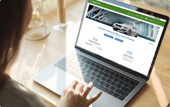 Laptop open with the AutoSMART website homepage on the screen