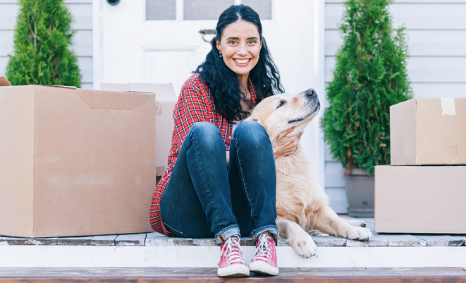 Woman sitting on stairs with dog