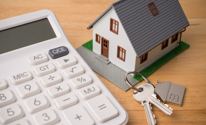 Calculator, house keys, and a house model