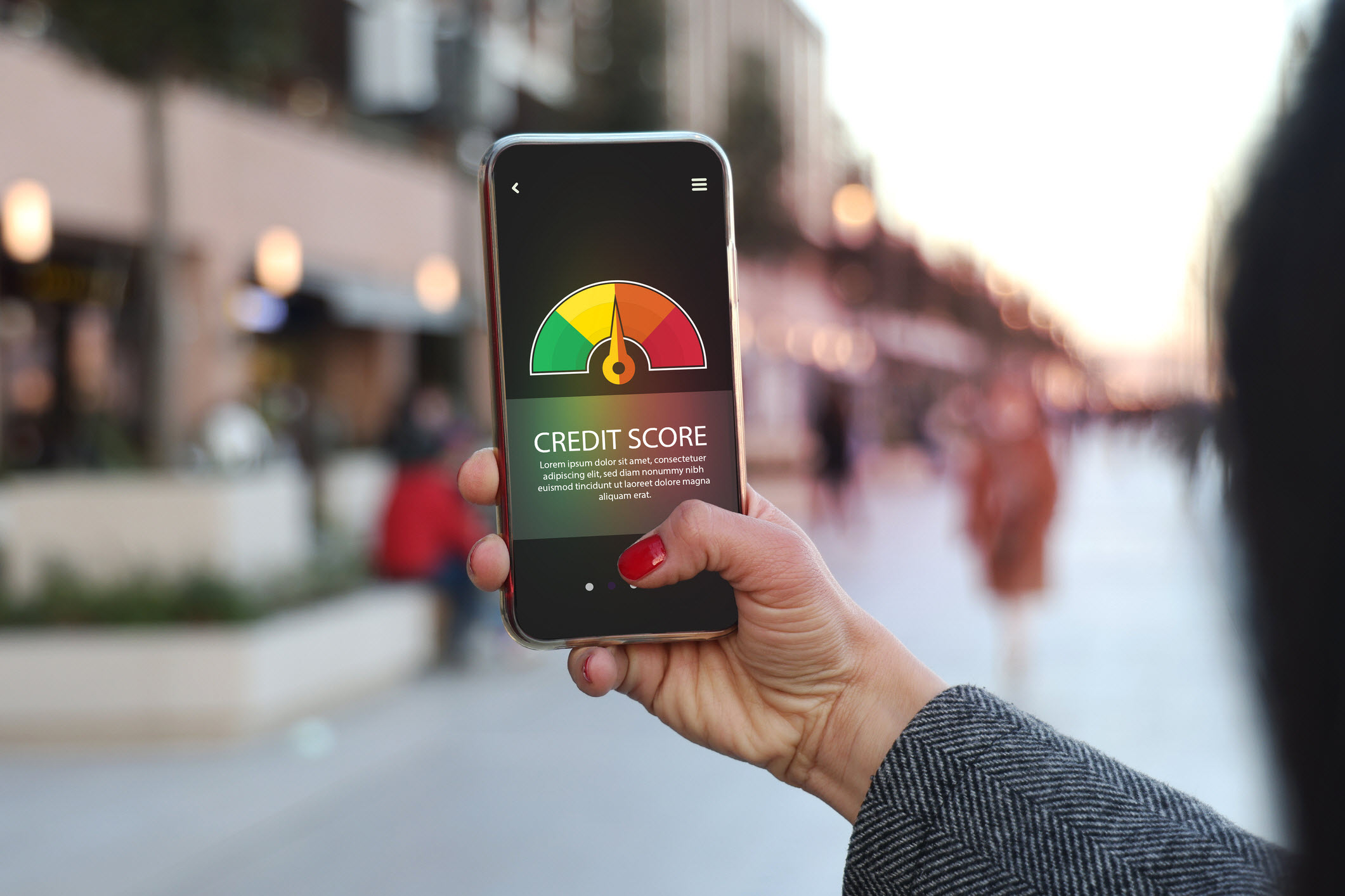 hand holding a mobile device checking credit score